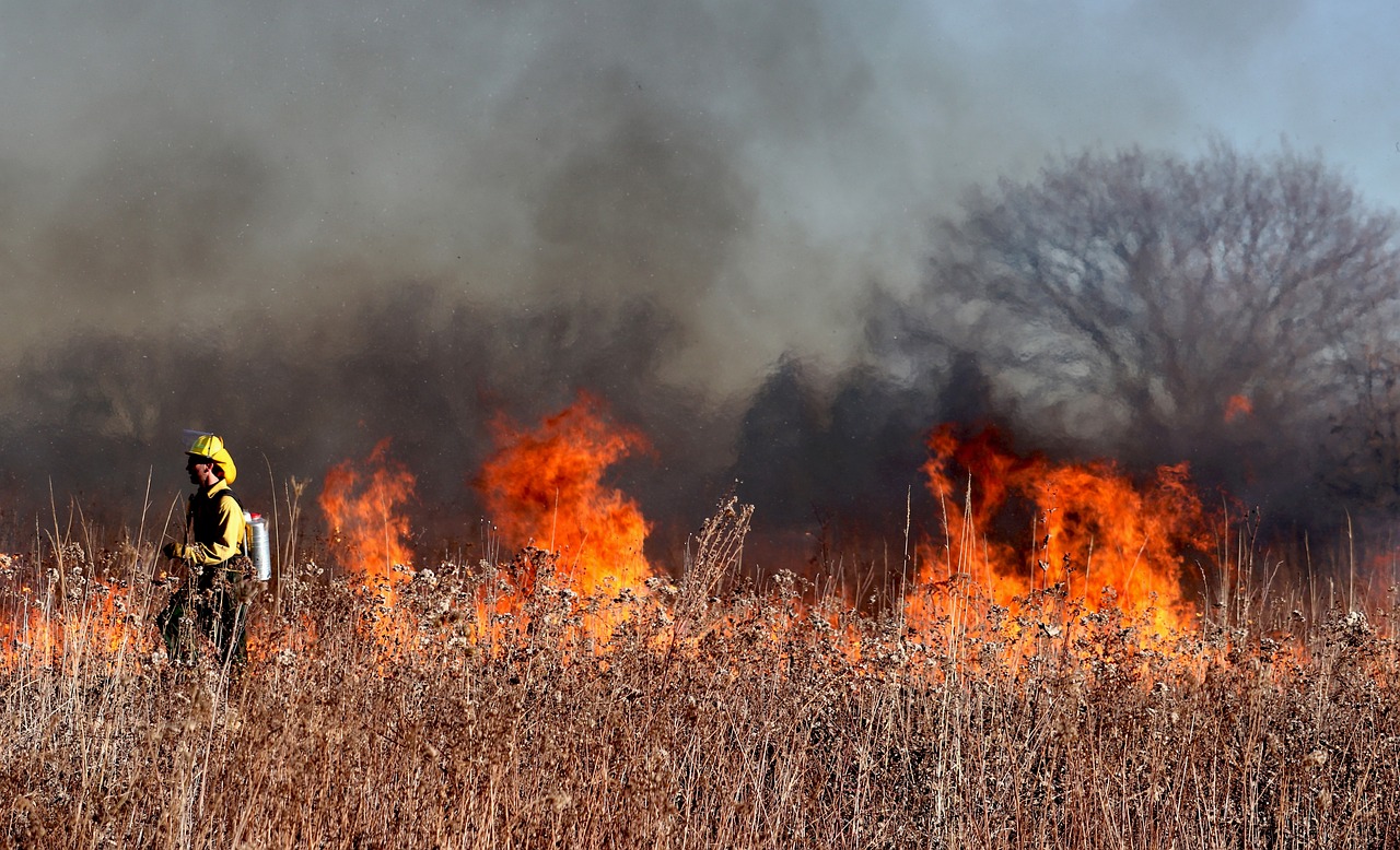 Climate change in Nigeria- firefighter near flames